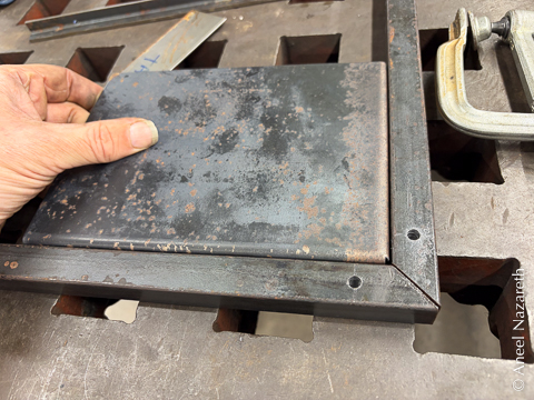 The folded sheet metal is placed inside the frame